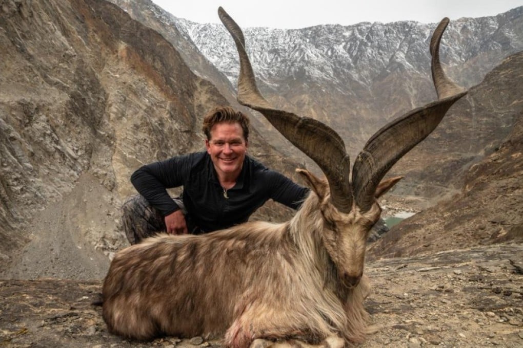 A hunter identified as Bryan Kinsel Harlan poses with his kill, a rare wild Astore markhor, in Pakistan. Photo: Supplied