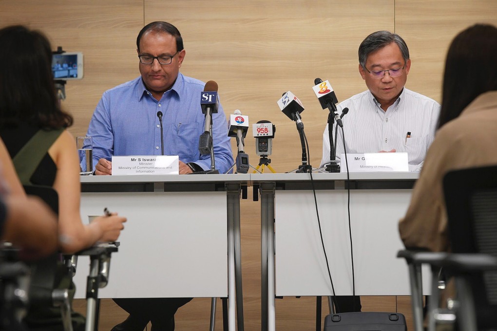 Singapore’s Communication and Information Minister S Iswaran (L) and health minister at a press briefing in July. Photo: EPA