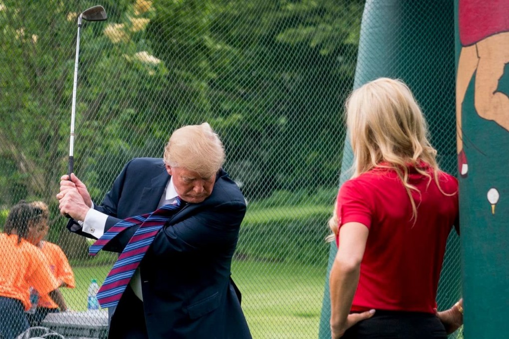 US President Donald Trump swings a golf club during the White House Sports and Fitness Day on the South Lawn in May 2018. File photo: AP