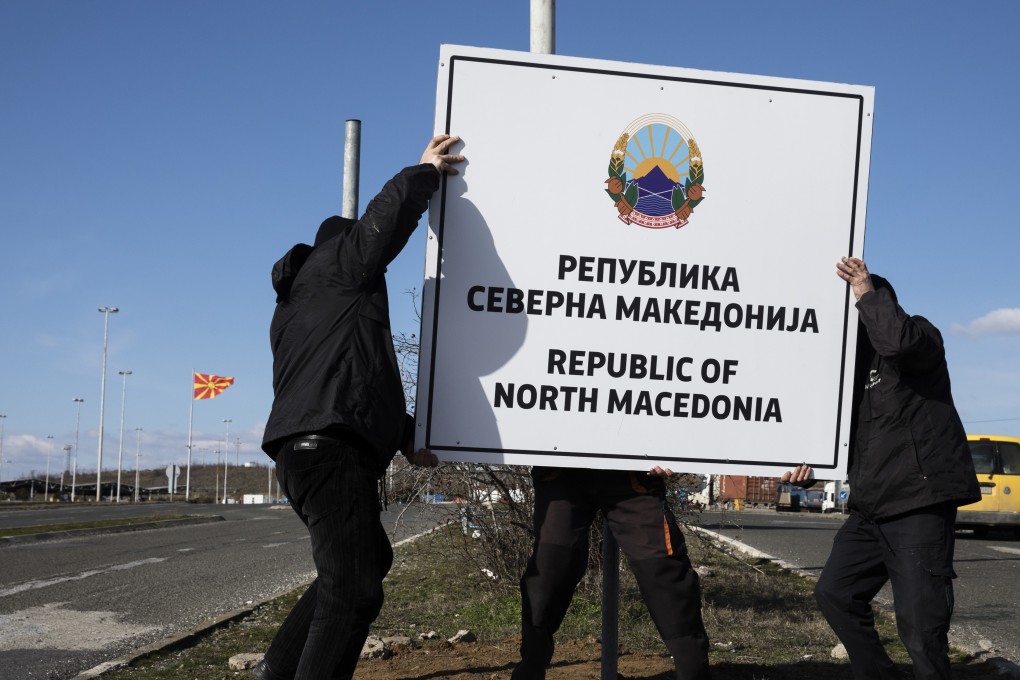 Workers erect a new road sign reading ‘Republic of North Macedonia’ at the Greece-Macedonia Bogorodica border crossing near Gevgelija, Republic of North Macedonia. Photo: Bloomberg