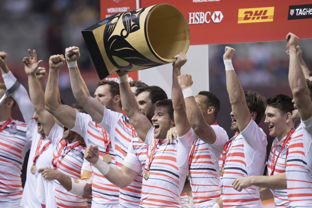 England’s Tom Mitchell (centre) hoists the trophy as he and his teammates celebrate after defeating South Africa to win the 2017 World Rugby Sevens Series event in Vancouver. Photo: AP
