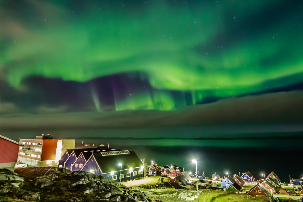 The Northern Lights over a village in Greenland Picture: Alamy