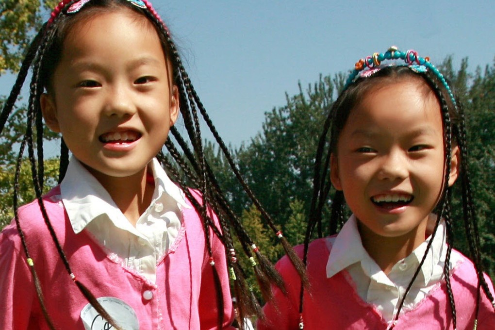 Chinese twins play at a park in Beijing. “Identical twins reared apart from birth are as similar as identical twins reared together in the same family”, professor of genetics Robert Plomin argues, citing studies of twins. Photo: AFP