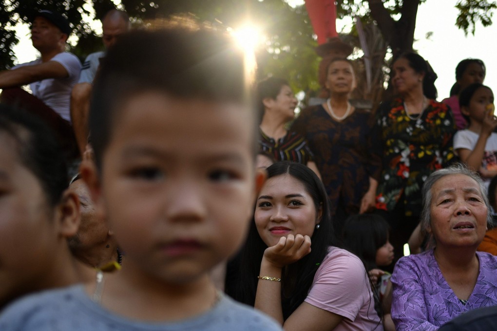 Vietnamese watch men wrestle for a ball during the traditional “Vat Cau” or ball wrestling festival on the fifth day of Tet, Vietnam’s Lunar New Year celebration. On his trip to Hanoi, Kim Jong-un may be shocked to discover just how capitalist Vietnam has become. Photo: AFP