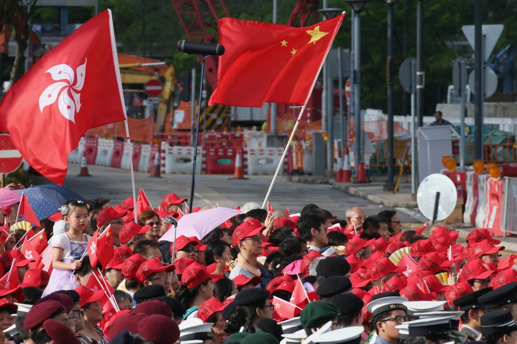 People wave the Chinese and Hong Kong flags at a flag-raising ceremony at the Golden Bauhinia Square in Wan Chai to mark the 21st anniversary of the establishment of the Hong Kong Special Administrative Region on July 1 last year. Photo: David Wong