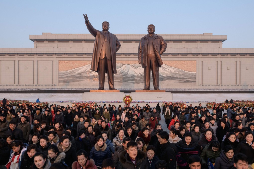 People leave after paying their respects before the statues of late North Korean leaders Kim Jong-il and Kim Il-sung in Pyongyang. Photo: AFP