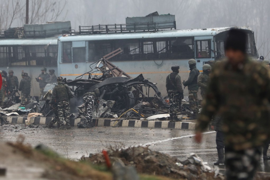 Indian security officers inspect the site of the blast in Jammu and Kashmir’s Pulwama district on Thursday. Photo: EPA-EFE
