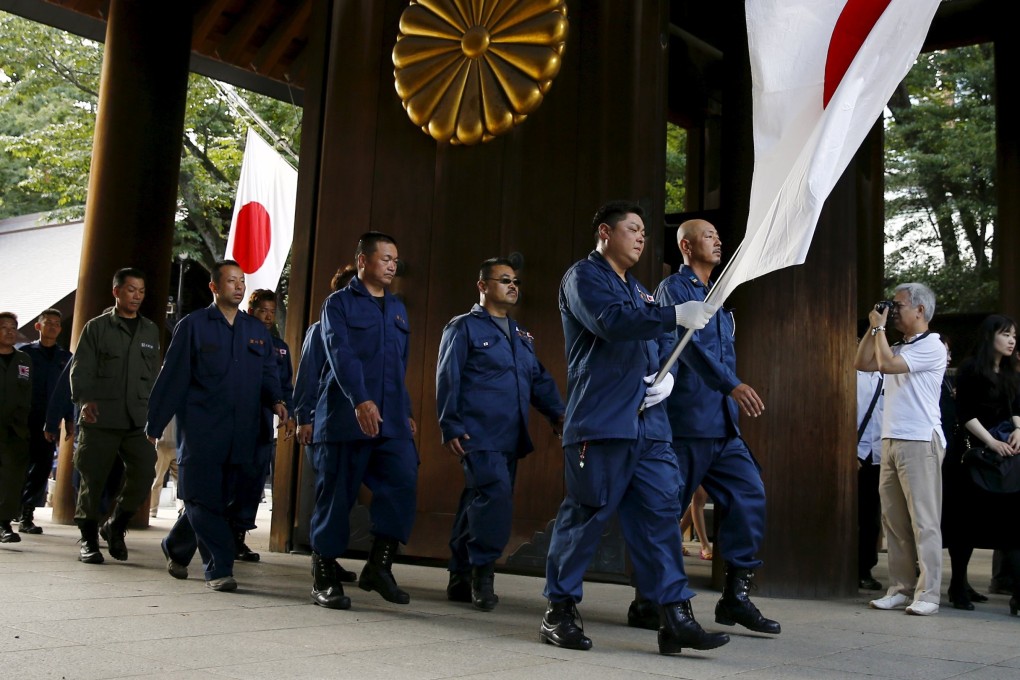 A group of Japanese right-wing activists enters Yasukuni Shrine. Photo: Reuters