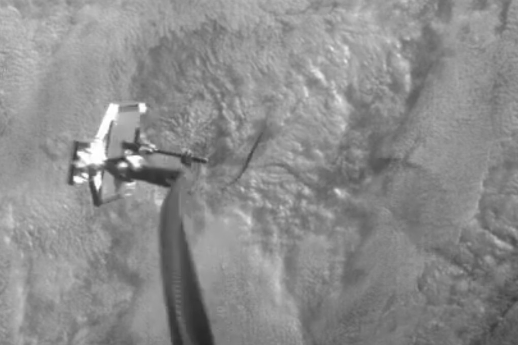 A harpoon from the RemoveDEBRIS spacecraft striking a square target. Photo: AP