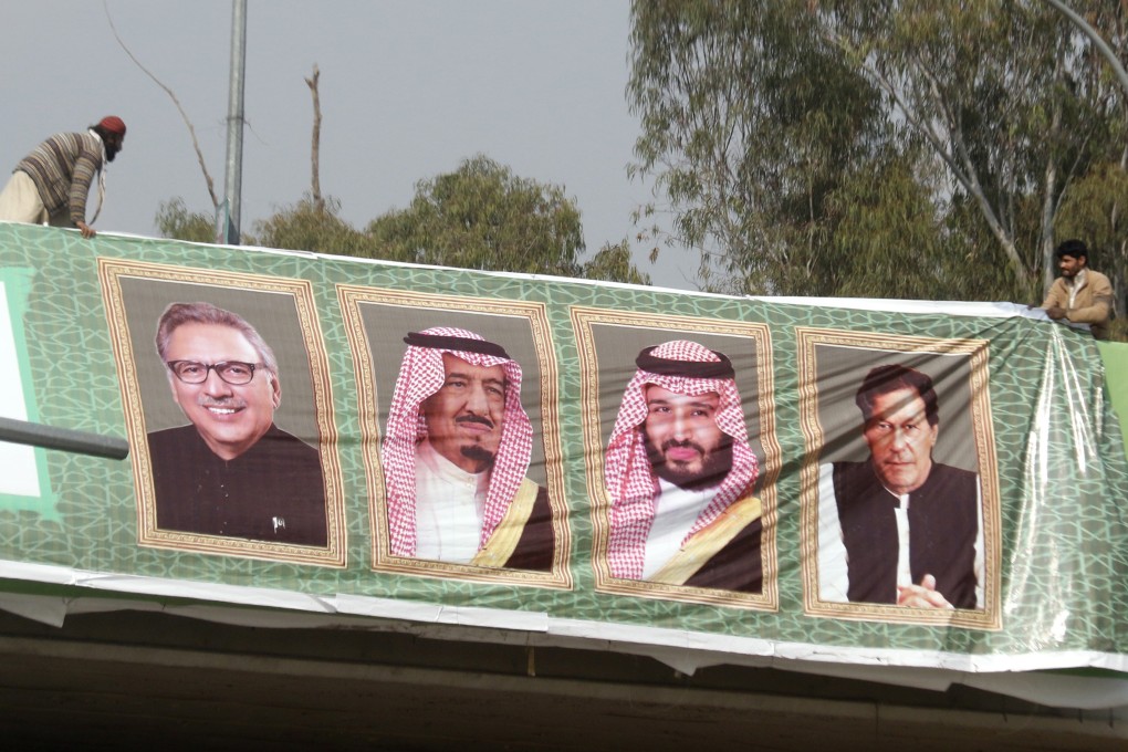 Workers hang pictures of Pakistan President Arif Ali, Saudi Arabia’s King Salman, Crown Prince Mohammad bin Salman and Pakistan’s Prime Minister Imran Khan on the eve of the prince’s visit to Islamabad, Pakistan on February 15, 2019. Photo: EPA