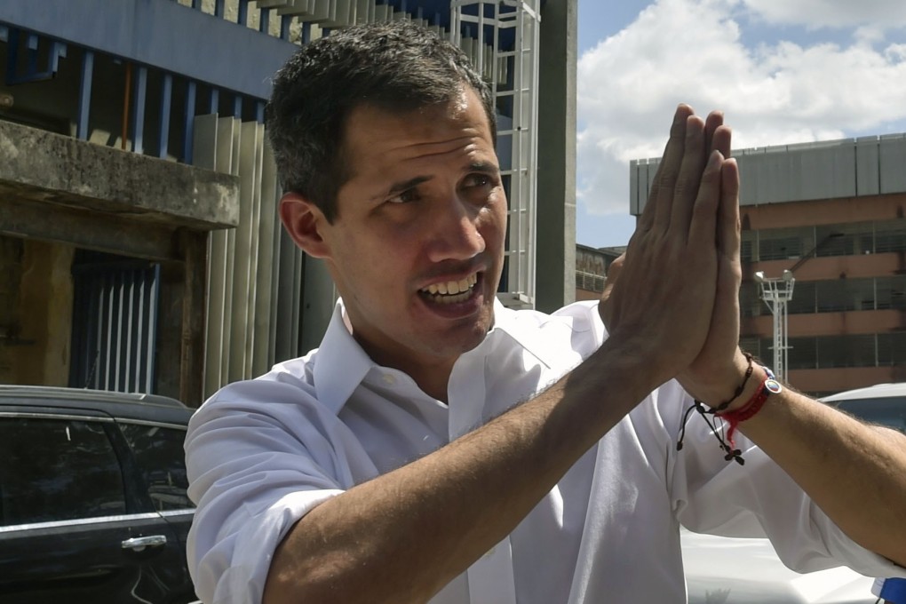 Venezuelan opposition leader and self declared acting president Juan Guaido gestures to supporters. Photo: AFP