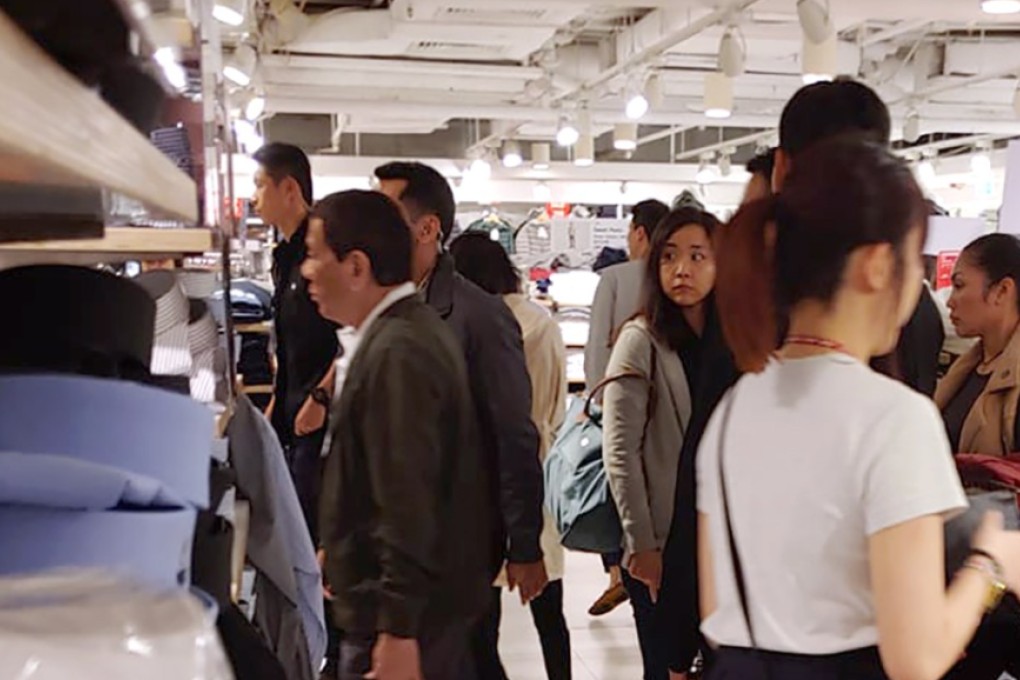 Rodrigo Duterte walks around the Uniqlo shop in Causeway Bay’s World Trade Centre – much to the surprise of some. Photo: Henry Chai