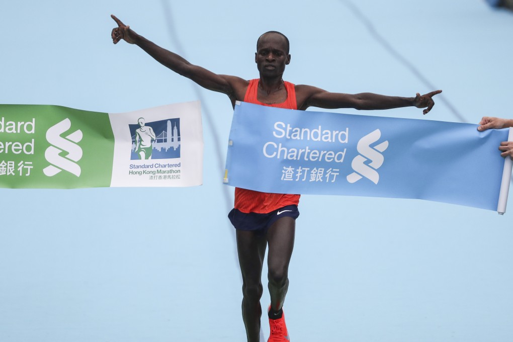 Kenya’s Barnabus Kiptum breaks the course record for the men’s marathon finish line in Victoria Park. 17FEB19 SCMP / Nora Tam
