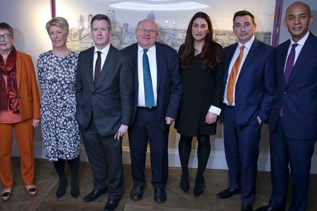 Former Labour MPs: Ann Coffey, Angela Smith, Chris Leslie, Mike Gapes, Luciana Berger, Gavin Shuker and Chuka Umunna pose for a photograph following a press conference in London on February 18, 2019. Photo: AFP