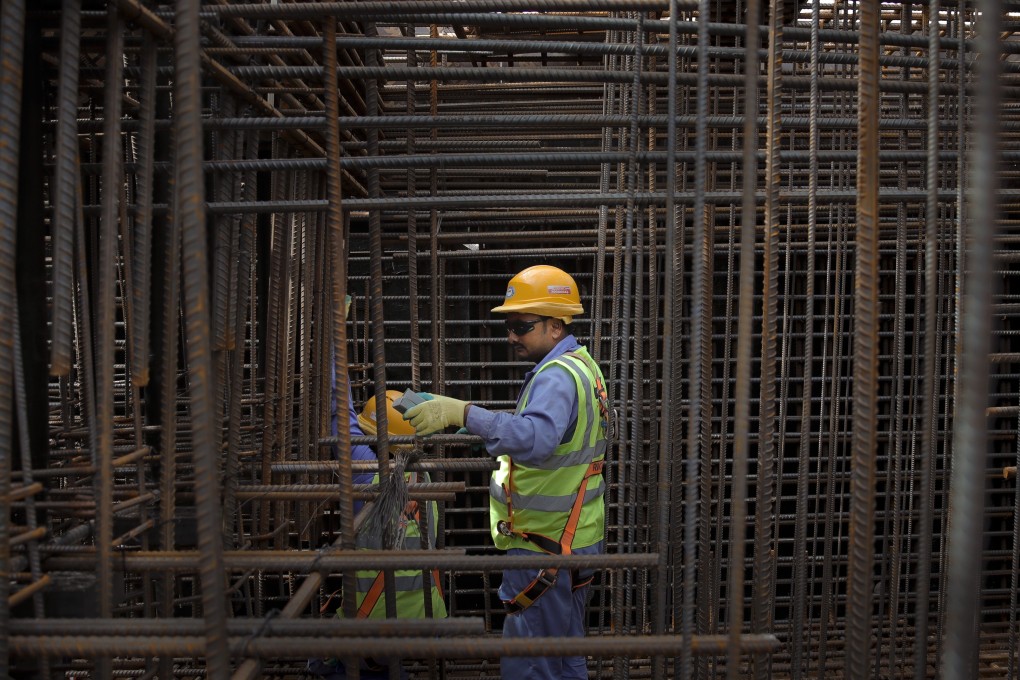 Builders working at the site of the Ras Abu Aboud stadium in Doha, Qatar. Photo: AP
