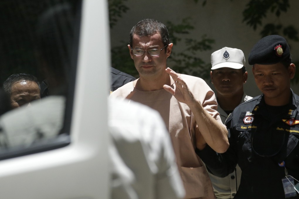 Xavier Justo (centre) leaves court in Bangkok after being sentenced to three years in prison, on August 17, 2015. Picture: AP