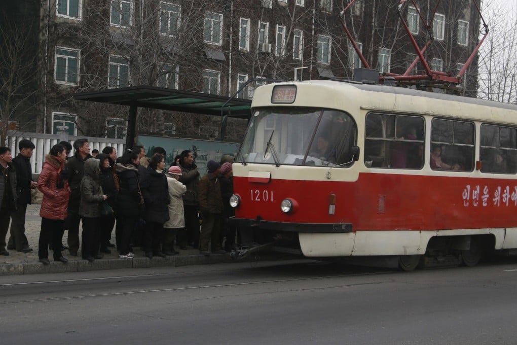People queue up to board a tram in Pyongyang, North Korea. Photo: AP