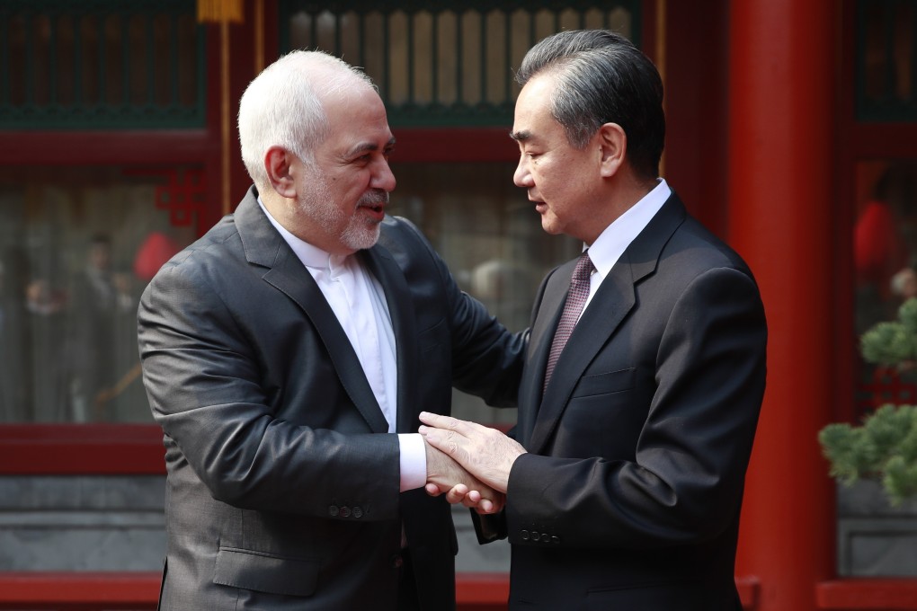 Iranian Foreign Minister Mohammad Javad Zarif and his Chinese counterpart Wang Yi shake hands during their meeting in Beijing on Tuesday. Photo: EPA-EFE