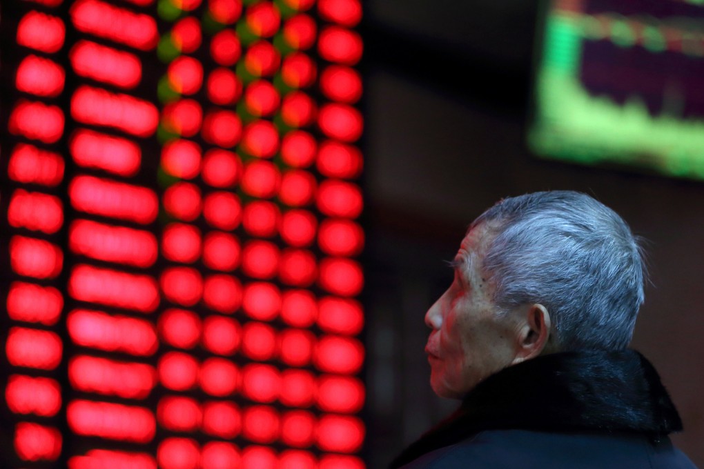 A man studies an electronic stock board at a brokerage house in Nanjing, Jiangsu province, China on February 13, 2019. Photo: Reuters