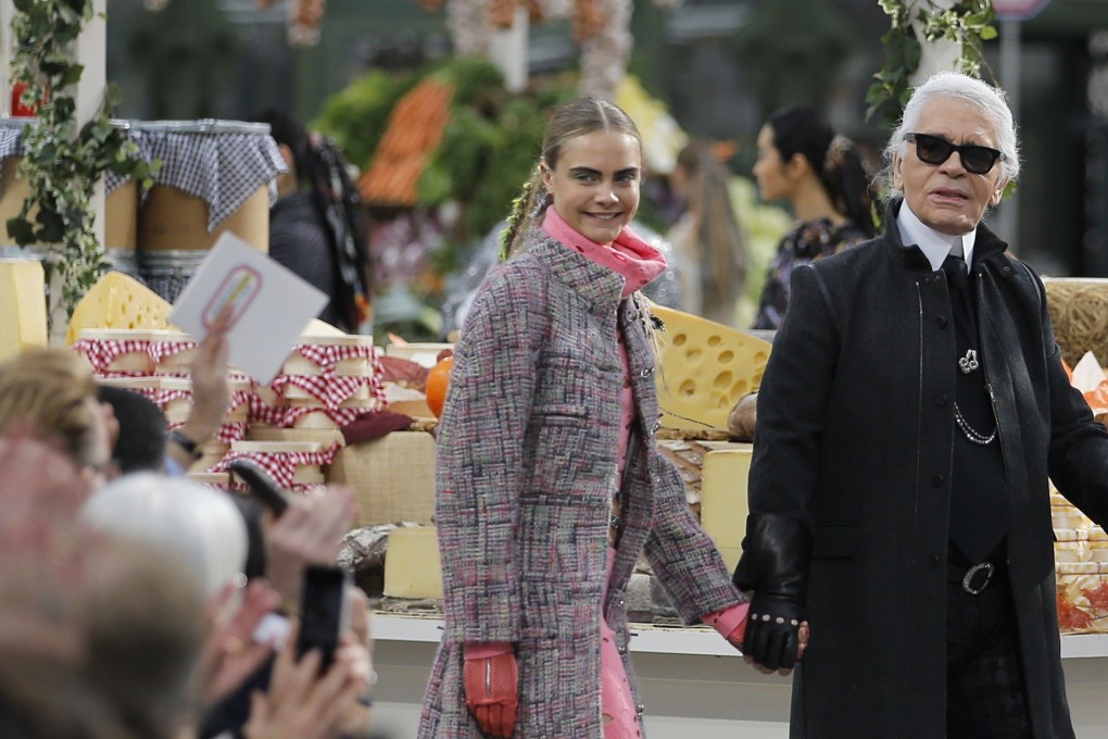 Karl Lagerfeld (right) with model Cara Delevingne, who has recently become involved in a war of words on Twitter defending the German fashion designer. Photo: Reuters