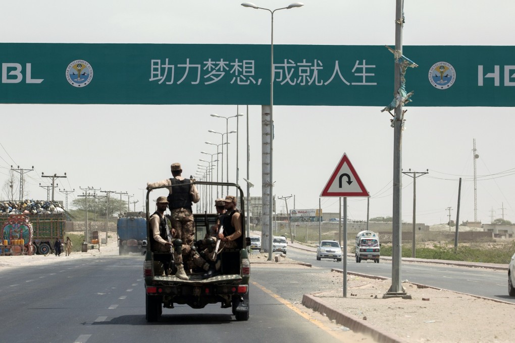 Security forces near a sign that reads “First Pakistani Branch in China” in Gwadar. Photo: Bloomberg