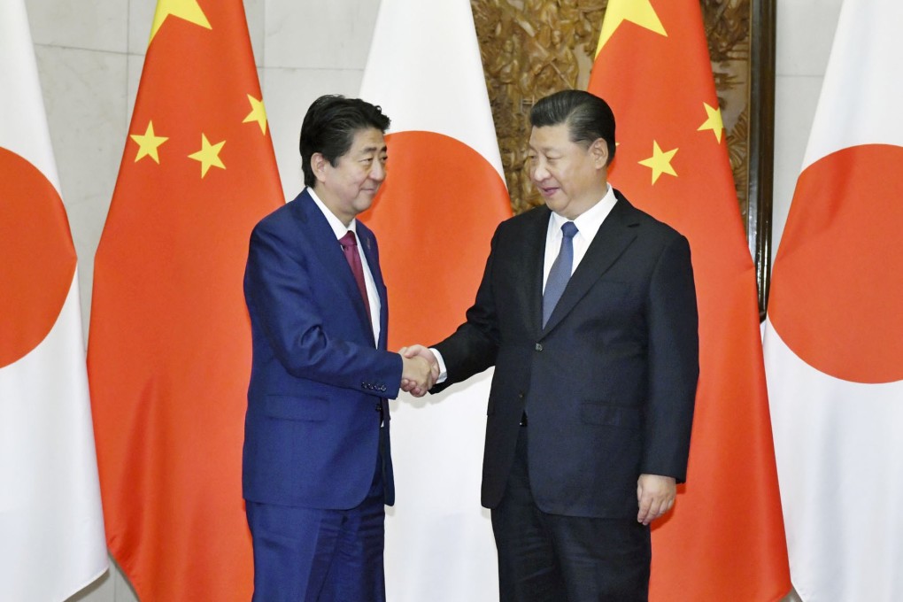 Japanese Prime Minister Shinzo Abe (left) shakes hands with Chinese President Xi Jinping during a visit to Beijing in October. Photo: AP