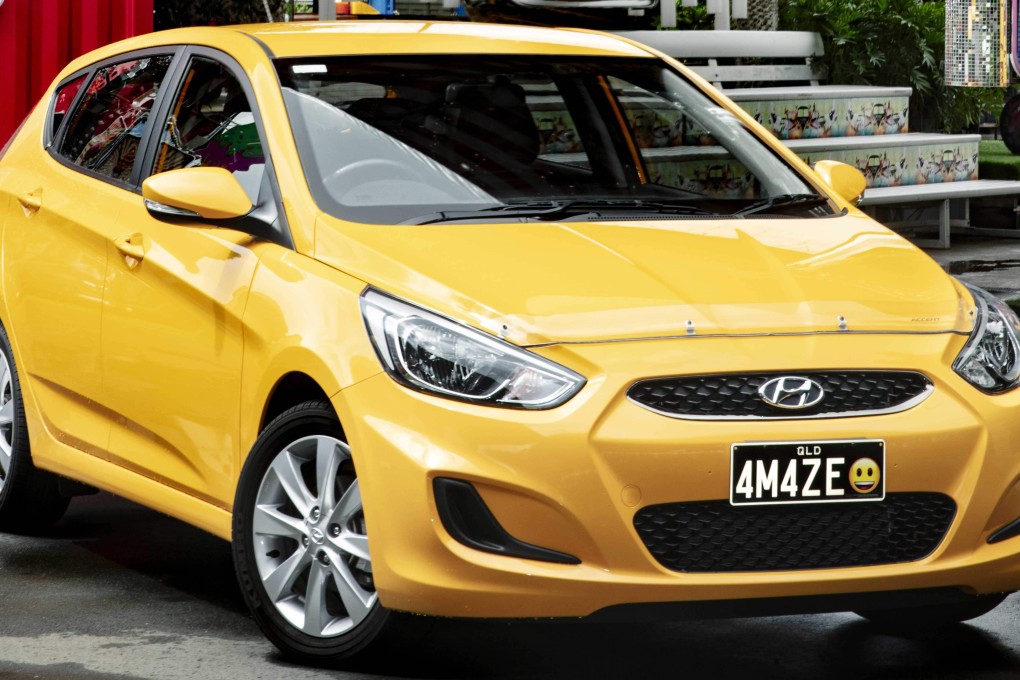 Personalised Plates Queensland displaying a car with a licence plate bearing a smiley emoji. Photo: AFP