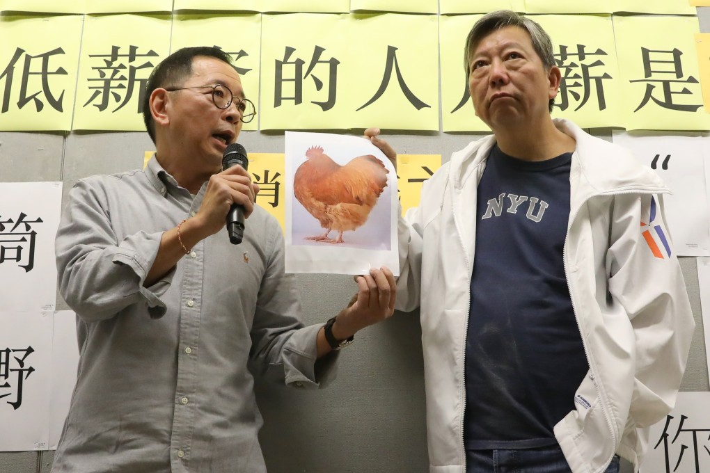Tse Wing-ling, chairman of the staff association, and HKCTU’s Lee Cheuk-yan put the riddle on the Democracy Wall to protest against the university management. Photo: K.Y. Cheng