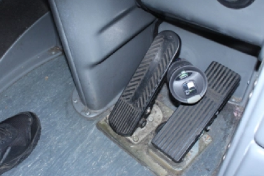 An NTSB recreation of how the 2017 bus accident in Flushing may have occurred, with the accelerator jammed down and the brake jammed up by a coffee vacuum flask. Photo: NTSB