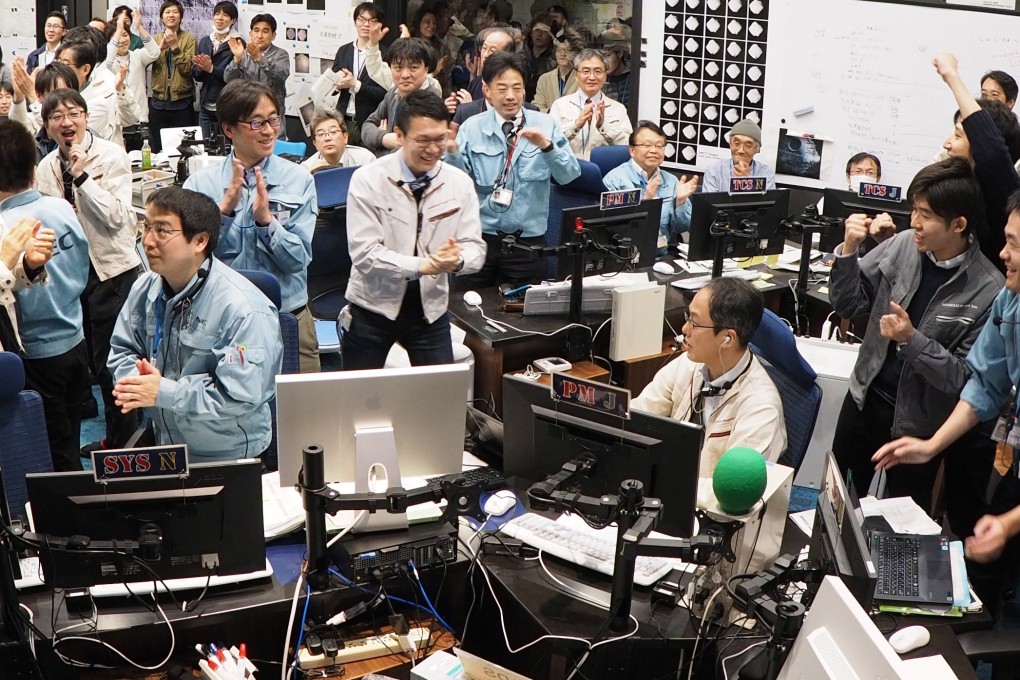 Japan Aerospace Exploration Agency (JAXA) and Institute of Space and Astronautical Science (ISAS) personnel reacting after they received confirmation that JAXA's Hayabusa2 space probe landed on the Ryugu asteroid. Photo: EPA