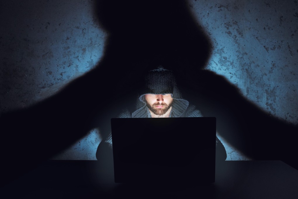 A male hacker working in dark empty room. Image: Alamy