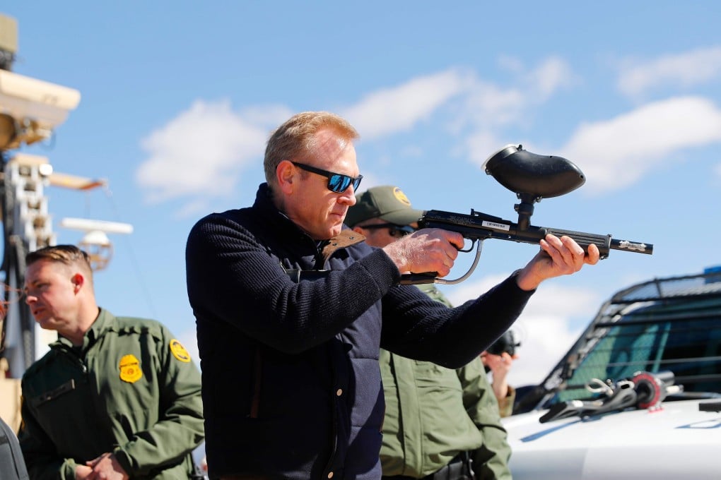 Acting Secretary of Defence Patrick Shanahan (C) fires a modified painted ball gun during a tour of the US-Mexico border at Santa Teresa Station in Sunland Park, New Mexico. Photo: AFP