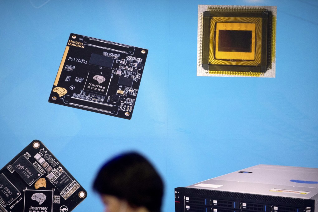 A visitor walks past a display showing microchips and circuit boards at the 21st China Beijing International High-tech Expo in Beijing. Photo: AP/Mark Schiefelbein