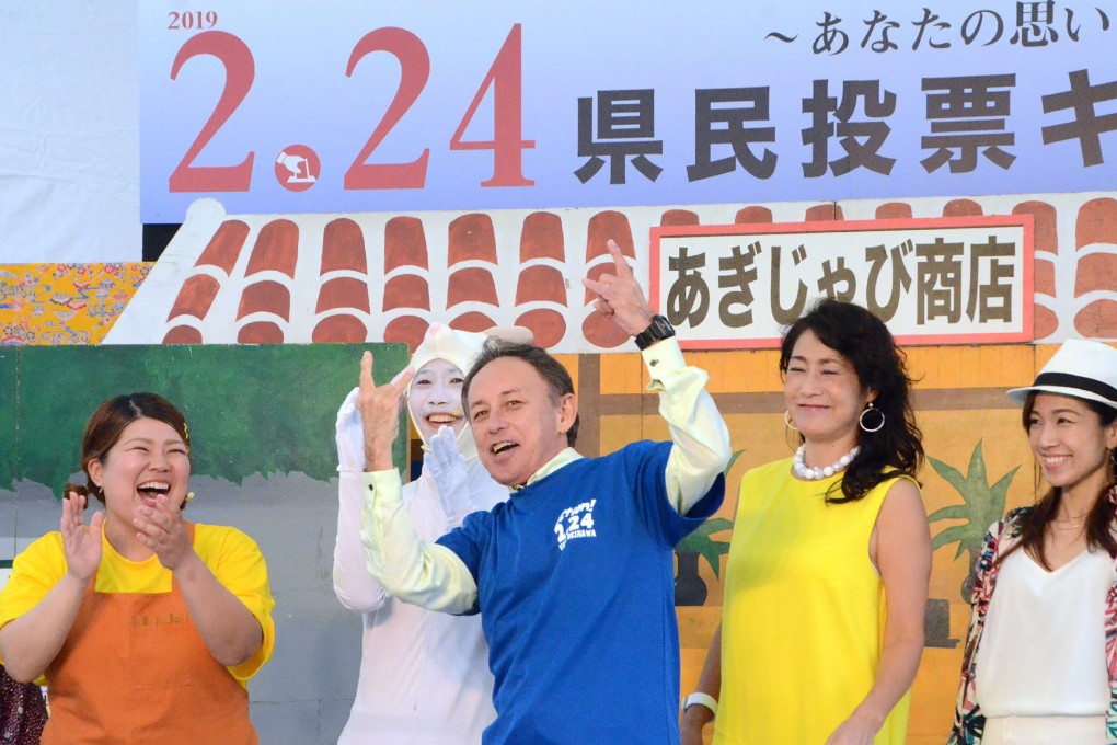 Denny Tamaki (centre), the governor of Okinawa, at a meeting in Naha on February 23, 2019. Photo by JIJI PRESS/AFP