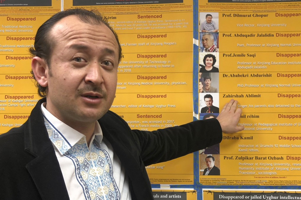 Abudwaris Ablimit points to a photo of his brother, Zahirshah, during a gathering in Washington DC to raise awareness of Uygurs who have disappeared in Xinjiang. Photo: AP
