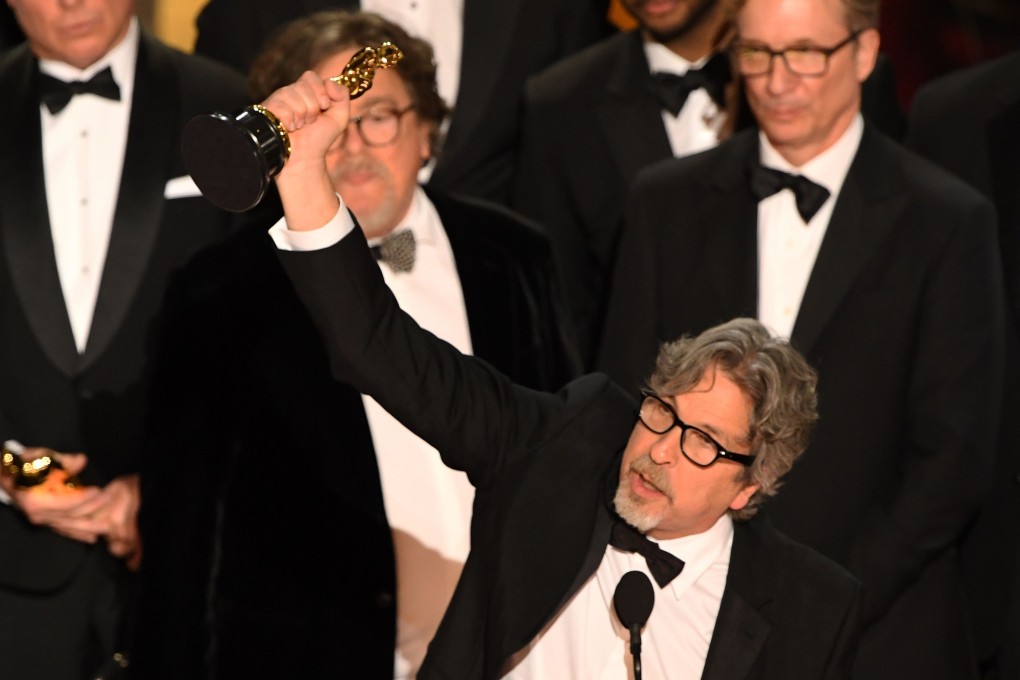 Director Peter Farrelly holds up the best picture Oscar for Green Book as his co-producers look on at the Dolby Theatre in Hollywood. Photo: AFP