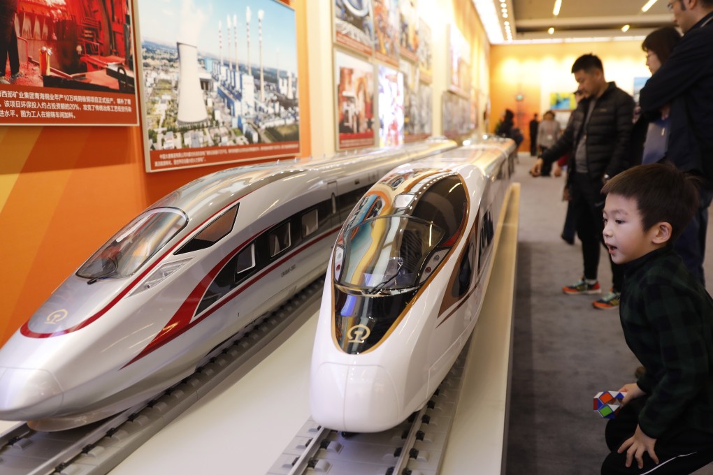 A boy looks at models of China’s Fuxing bullet train at an exhibition marking the 40th anniversary of the country’s reform and opening up at the National Museum of China in Beijing in November 2018. Photo: EPA-EFE