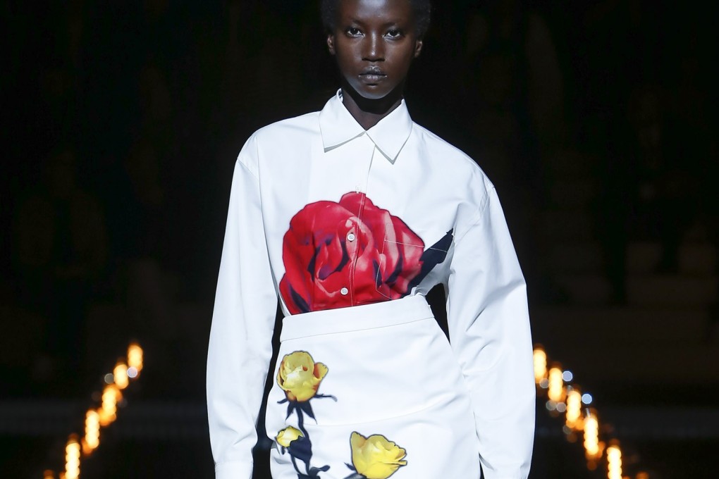 A model shows a Prada flower-appliqué dress on the catwalk at Milan Fashion Week. This will be the look of autumn and winter 2019.