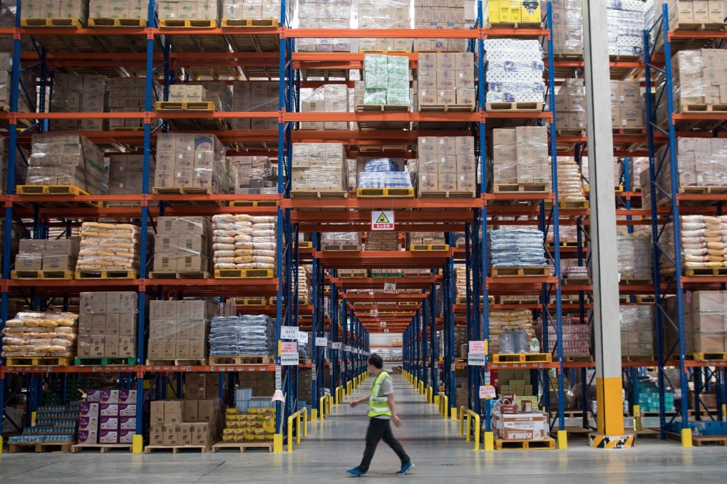 Workers in a TMall.com warehouse gather orders from customers in Jiangmen, Guangdong province. The combination of surging demand for high-standard warehouses from e-commerce companies, third-party logistics providers and manufacturers, coupled with a scarcity of land in major urban centres and tight land-use restrictions, has led to strong absorption of warehousing space. Photo: EPA-EFE