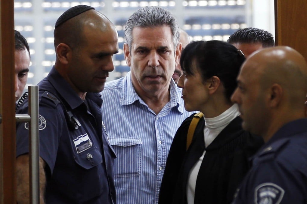 A July 2018 photo of Gonen Segev (centre), a former Israeli cabinet minister indicted on suspicion of spying for Iran, at the court in Jerusalem. Photo: AFP