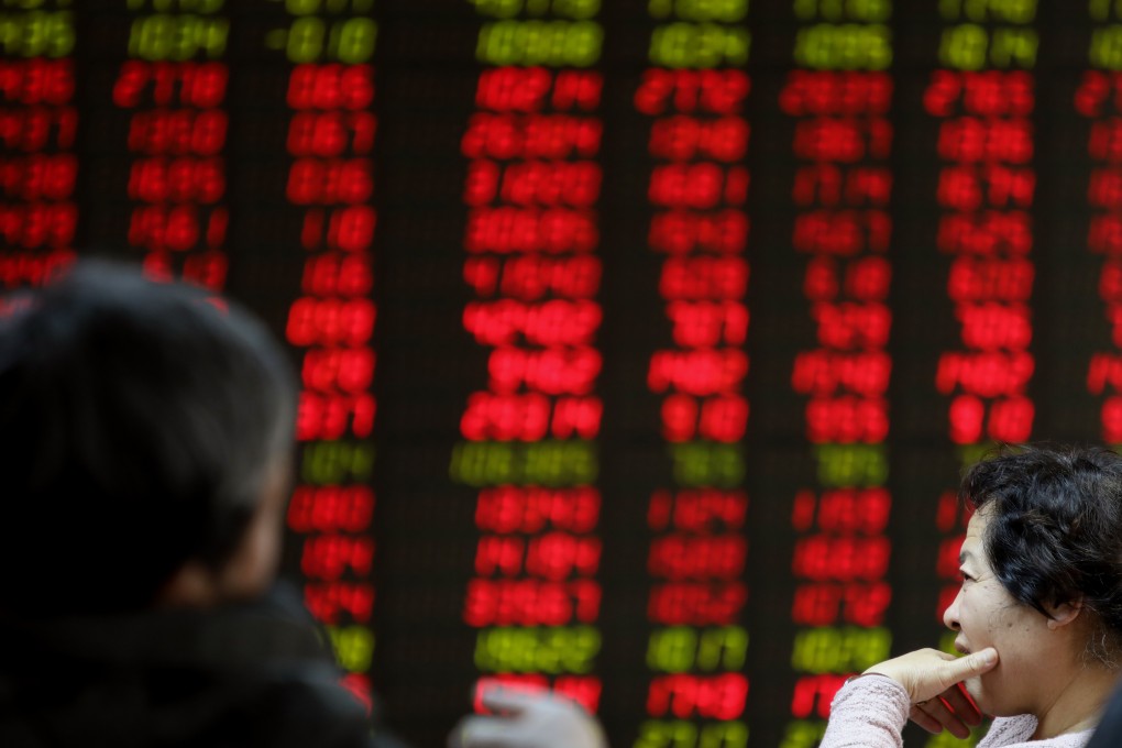 Investors monitor stock prices at a brokerage house in Beijing on November 16, 2018. Photo: Simon Song