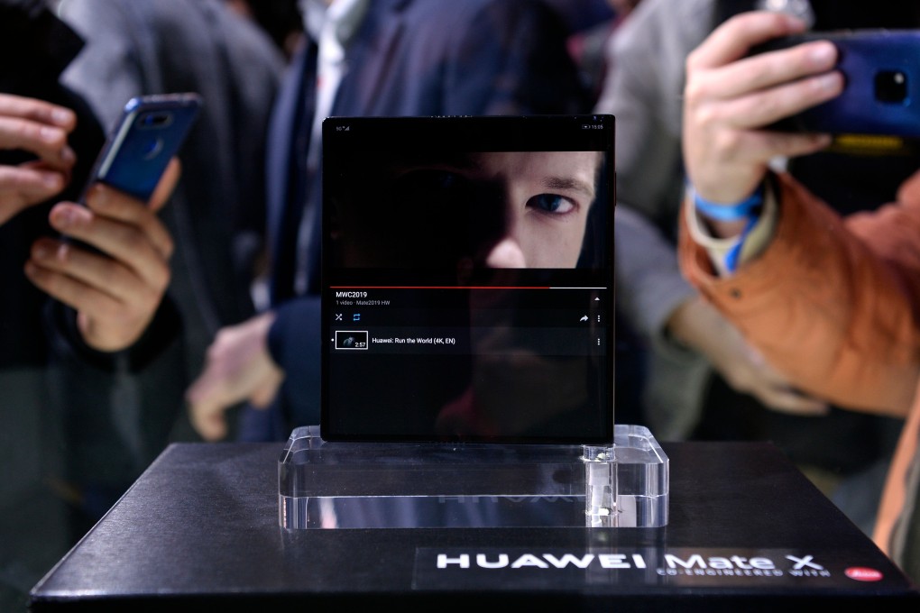 Visitors take images of Huawei's new foldable 5G smartphone Huawei Mate X at the Mobile World Congress (MWC), on the eve of the world's biggest mobile fair, on February 24, 2019 in Barcelona. Photo: Josep LAGO/AFP