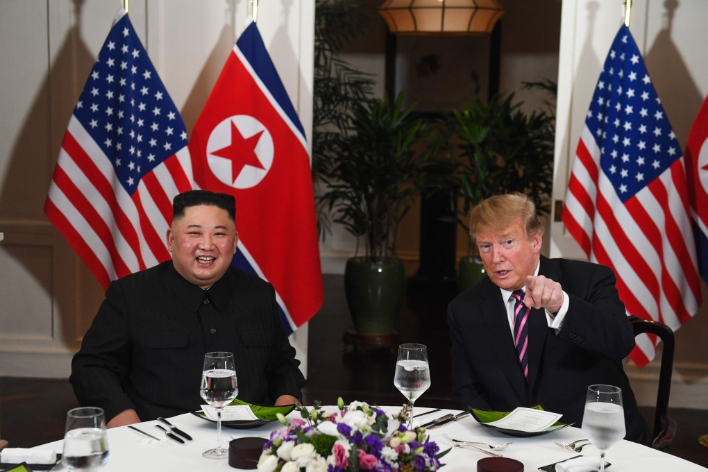 US President Donald Trump (R) speaks with North Korea's leader Kim Jong Un as they sit for a dinner at the Sofitel Legend Metropole hotel in Hanoi on February 27, 2019. (Photo by Saul LOEB / AFP)