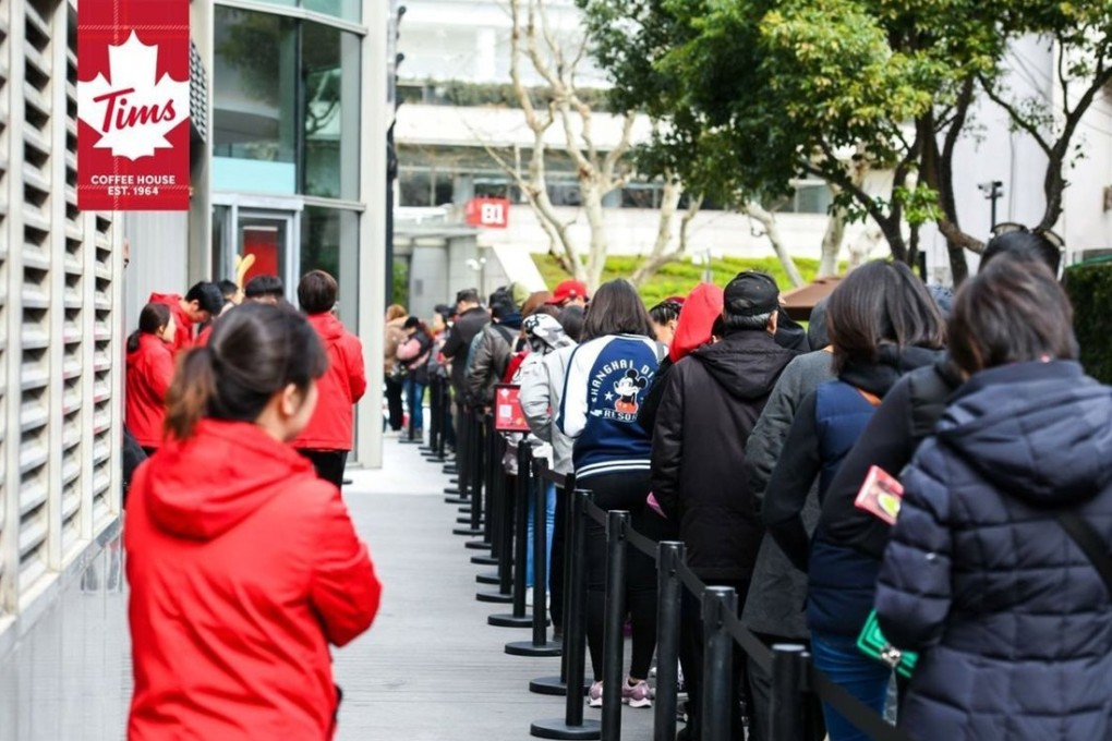 Customers queue up outside the new Tim Hortons cafe in Shanghai on Tuesday. Photo: Tim Hortons