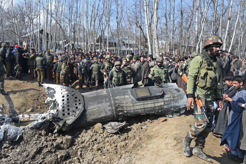 Indian soldiers and Kashmiri onlookers stand near the remains of an Indian Air Force plane after it crashed in Budgam district, some 30km from Srinagar, on Wednesday. Photo: AFP