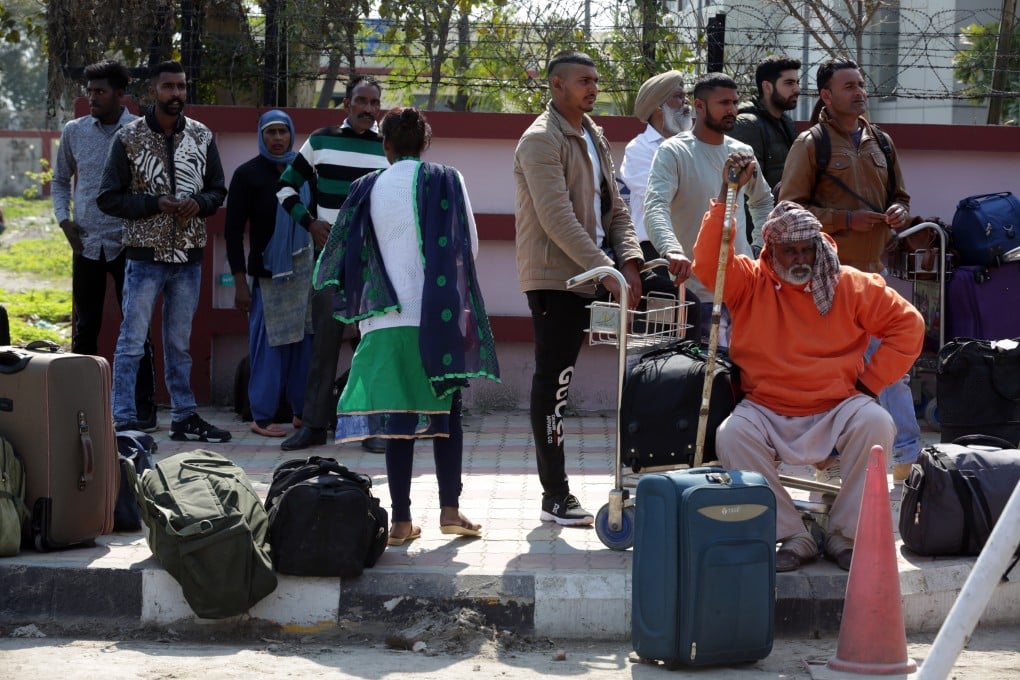 Stranded passengers sit with their belongings outside the Sri Guru Ramdas Ji International Airport in wake of border tension between India and Pakistan. Photo: EPA