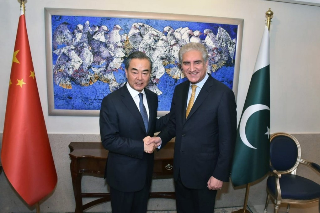 Pakistan’s Foreign Minister Shah Mehmood Qureshi (right) appealed to his Chinese counterpart Wang Yi (right) to help resolve its conflict with India. Photo: EPA-EFE