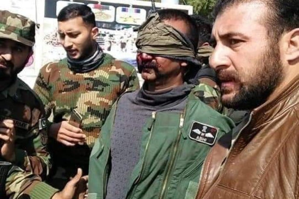 Wing Commander Abhinandan Varthaman is seen bloodied and with his eyes blindfolded in a scene from a video shared on social media. Photo: YouTube