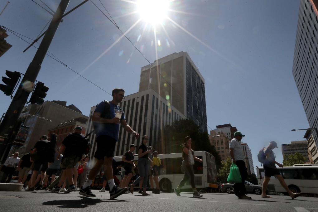 Pedestrians are seen during the hot weather in Adelaide, where an Extreme Heatwave Emergency Warning was effective from 28 February. Photo: EPA