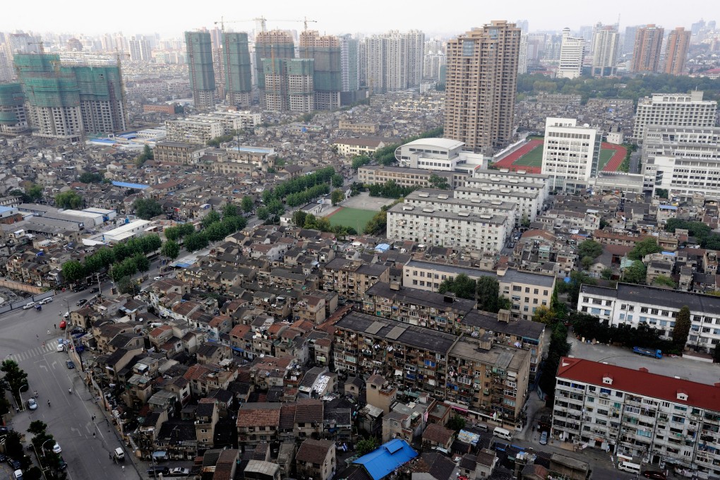 A view of the Hongkou district in Shanghai, with apartments under construction in the background, and traditional low rise homes in the foreground, as of October 8, 2009. Photo: Alamy